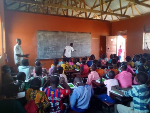 Signpost International Lomokori primary pupils being taught by Headteacher