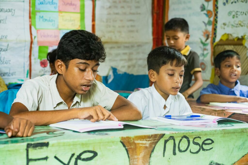 A boy reads in class as part of a Children on the Edge project in Thailand for Rohingya refugees